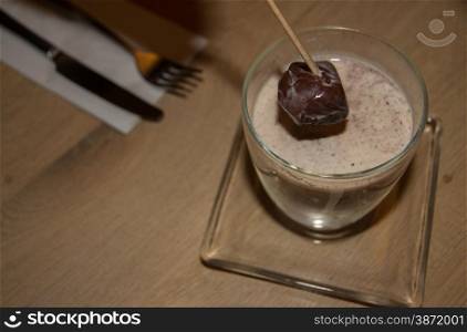 Belgian Chocolate on a stick, which dissolves in hot milk to make a drink. Focus on half melted chocolate.