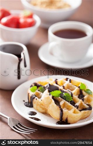 Belgian waffles with chocolate and powder sugar for breakfast