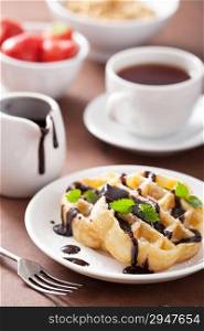 Belgian waffles with chocolate and powder sugar for breakfast