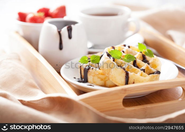 Belgian waffles with chocolate and powder sugar for breakfast