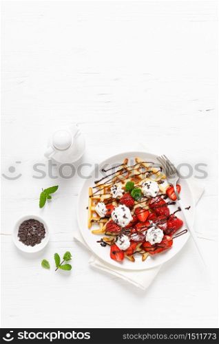 Belgian waffles with fresh strawberry, chocolate topping and whipped cream