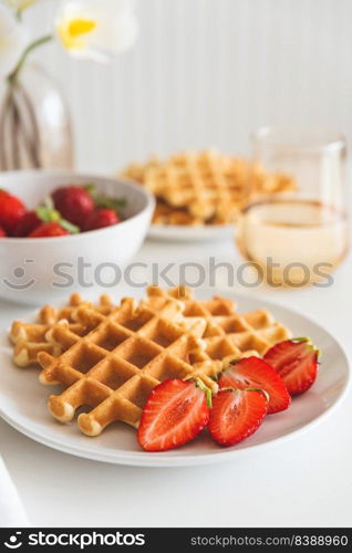 Belgian waffles with strawberry on white plate. Breakfast food concept