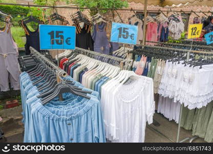BELGIUM - BOMAL SUR OURTHE - JUNE 4, 2017: Clothes on the sunday market at Bomal Sur Ourthe in Belgium.