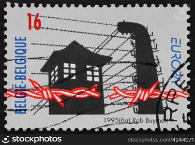 BELGIUM - CIRCA 1995: a stamp printed in the Belgium shows Broken Barbed Wire, Prison Guard Tower, 50th Anniversary of Liberation of Concentration Camps, circa 1995
