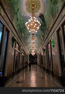 BELGIUM, January 2019, People at walking across corridor decorated with beautiful chandeliers