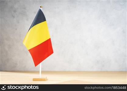 Belgium table flag on white textured wall. Copy space for text, designs or drawings