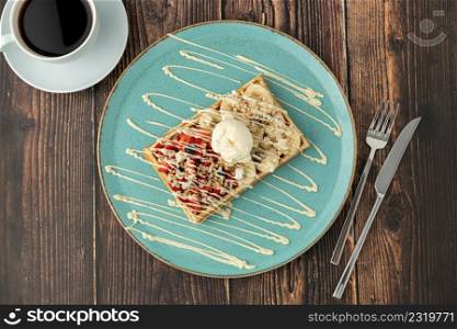 belgium waffles with strawberry and banana and a cup of coffee
