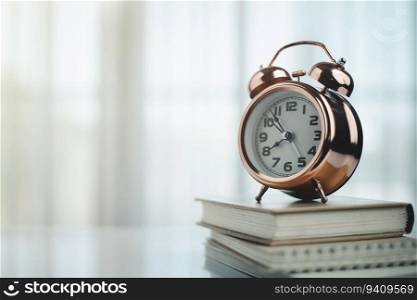 Bell alarm clock on books with copy space for time management for study and work concept