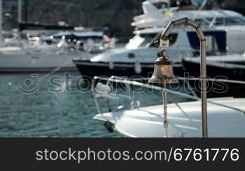 Bell in emergency on a background of yachts