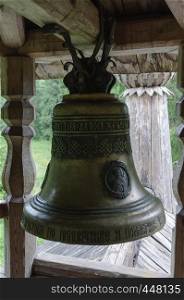 Bell in small wooden orthodox chapel on the Maura mountain, near Goritsa village, Vologda region, Russia