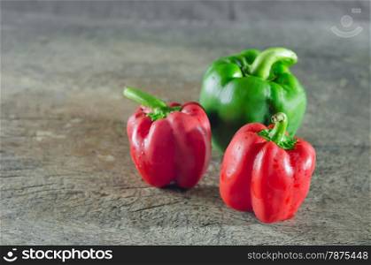 bell pepper. red and green bell peppers on wooden table