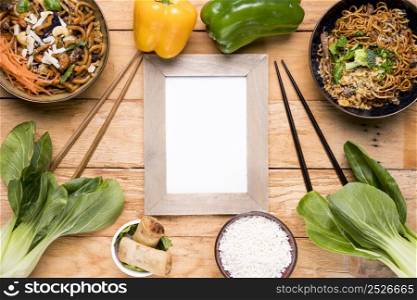 bell peppers bokchoy chopping stick spring rolls rice udon noodles bowl wooden desk
