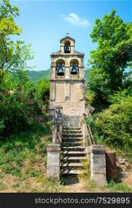 Bell tower near the village Prcanj. Montenegro. Separate belfry on the background of the mountain.. Separate belfry in Prcanj