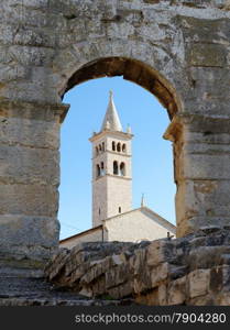 Bell tower of Saint Anthony Church in Pula, Croatia seen through the arc of Pula Amphitheater. Bell tower of Saint Anthony Church in Pula, Croatia seen through the arc of Pula Amphitheater