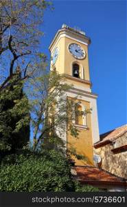 Bell tower with a clock in the old French town