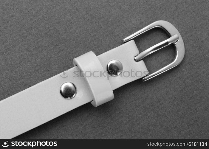 belt with a buckle on a gray background