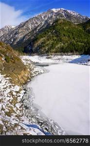 Benasque frozen reservoir Paso Nuevo in Pyrenees of Spain