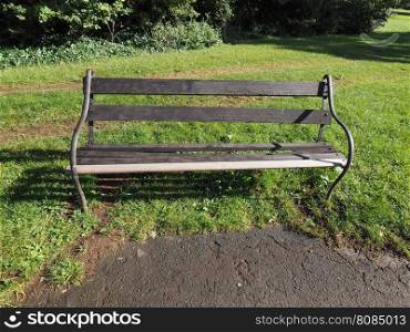 Bench in park. A wooden bench in a public park