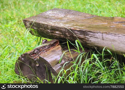 Bench made of logs in the meadow