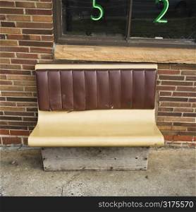 Bench seat outside brick building.