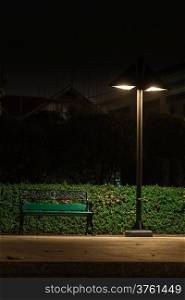 Bench under a lamp In the park alone at night.