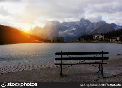 Bench with scenic alpine mountain lake view, Misurina lake, Dolomites Alps, Italy