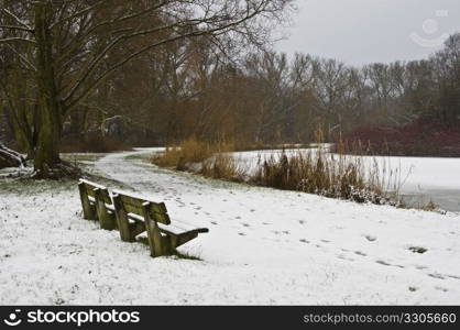 benches in a park covered with snow