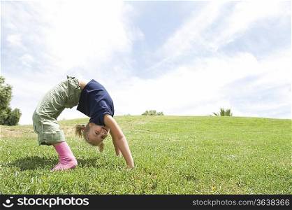 Bending over backwards girl on grass