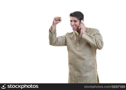 Bengali man cheering while talking on a mobile phone