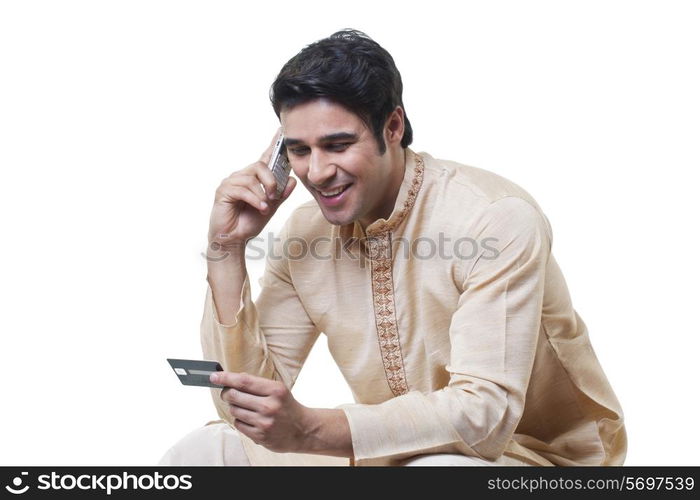 Bengali man paying by credit card on mobile phone