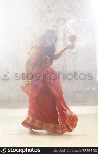 Bengali Married women performing dhunuchi dance on the occasion of durga puja
