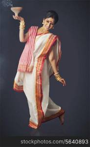 Bengali woman doing a dhunuchi dance
