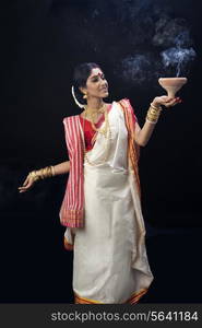 Bengali woman doing a dhunuchi dance