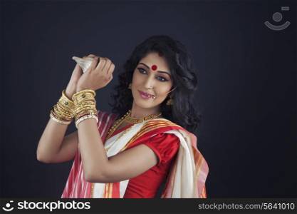 Bengali woman holding a conch shell