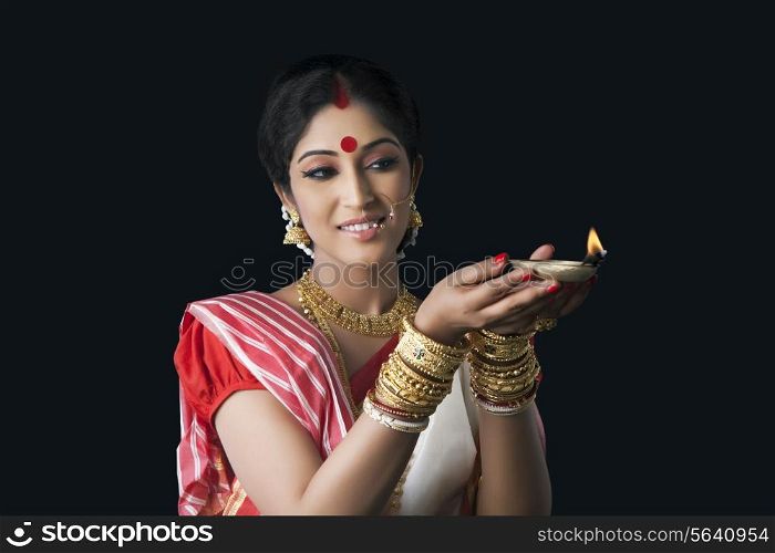 Bengali woman holding a diya