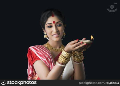 Bengali woman holding a diya