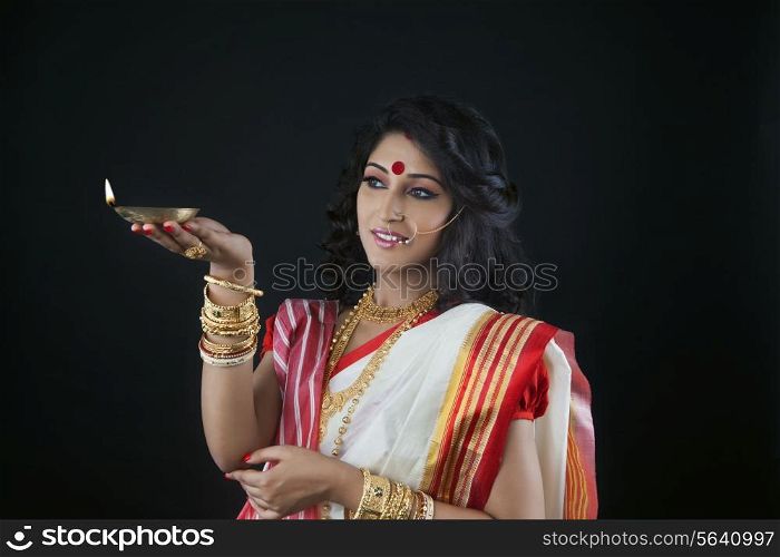 Bengali woman holding a diya