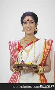 Bengali woman holding a puja thali