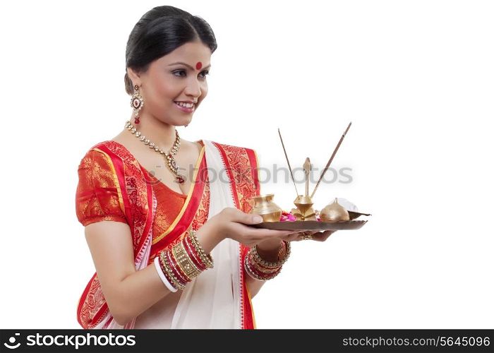 Bengali woman holding a puja thali