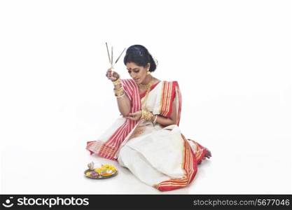 Bengali woman holding an agarbatti
