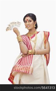 Bengali woman holding currency notes