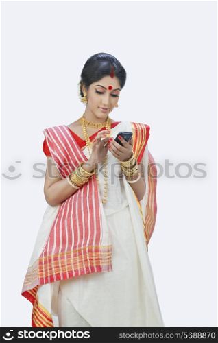 Bengali woman typing message on mobile phone