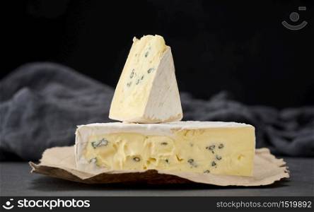 bergader blue cheese on a black wooden board, delicious snack