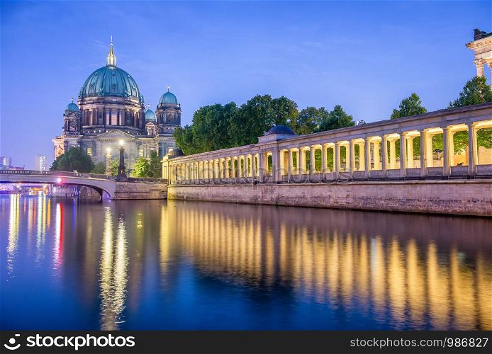 Berlin Cathedral at night along city river, Germany.