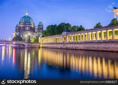Berlin Cathedral at night along city river, Germany.