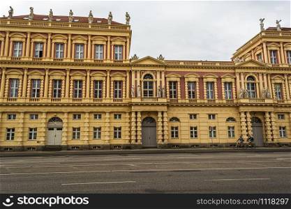 Berlin, Germany - August 17 2019 - View of historical building in Potsdam, Germany with two cyclists. View of historical building in Potsdam, Germany with two cyclists