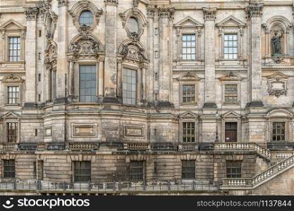 Berlin, Germany - December 9, 2019: Part of wall with windows of Berliner Dom - The largest evangelical church in Germany.. The largest evangelical church in Germany architectural fragment.