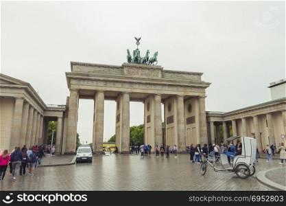 Berlin, Germany - May 16, 2017: Tourists at Brandenburg Gate. The Brandenburg Gate is a triumphal arch, a city gate in the center of Berlin. It is one of the most known sites in Berlin.
