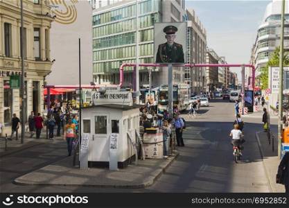 Berlin, Germany - May 17, 2017: Tourists at Checkpoint Charlie. former Berlin Wall border crossing point between East and West Berlin during the Cold War.