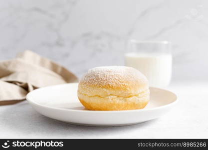 Berliner donut. Traditional german donut with raspberry jam, dusted with icing sugar